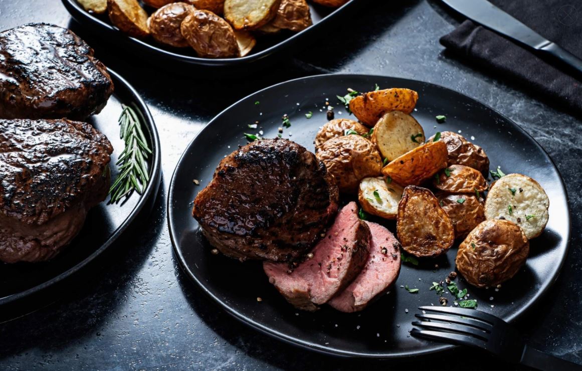 Seared Beef Petite Tender on plate with potatoes