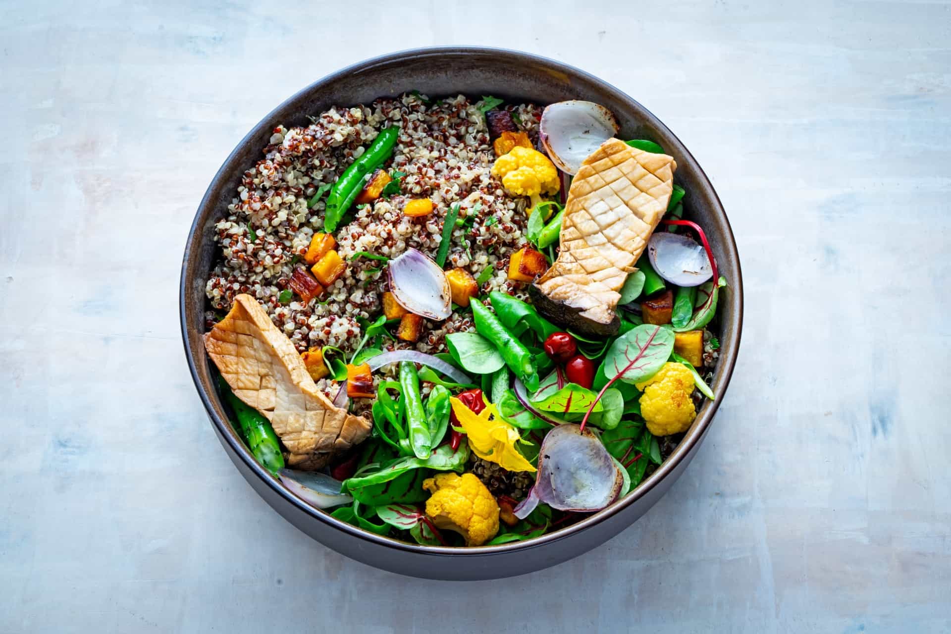 Quinoa Blend with greens topped with seared salmon