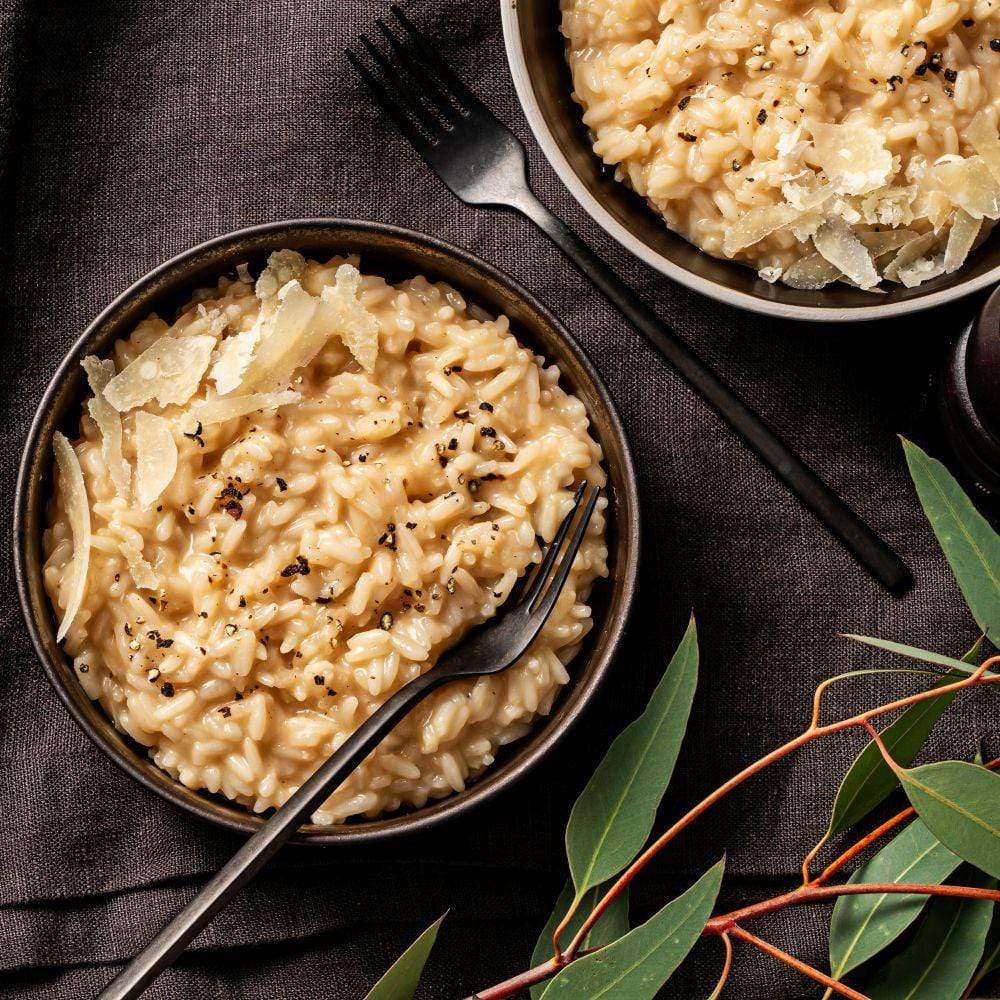 White Wine Risotto in bowl with flakes of cheese topping