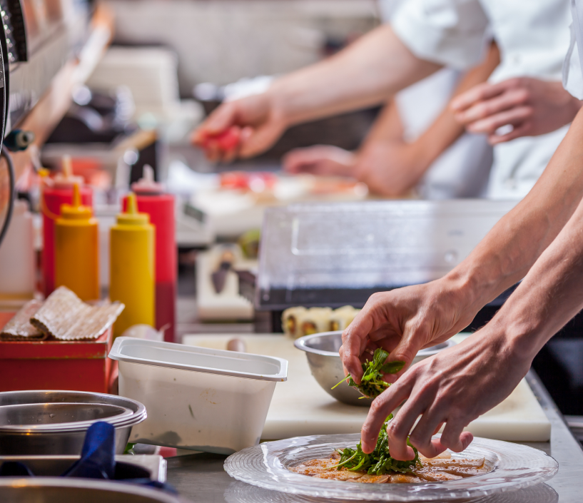 chef placing toppings on plate